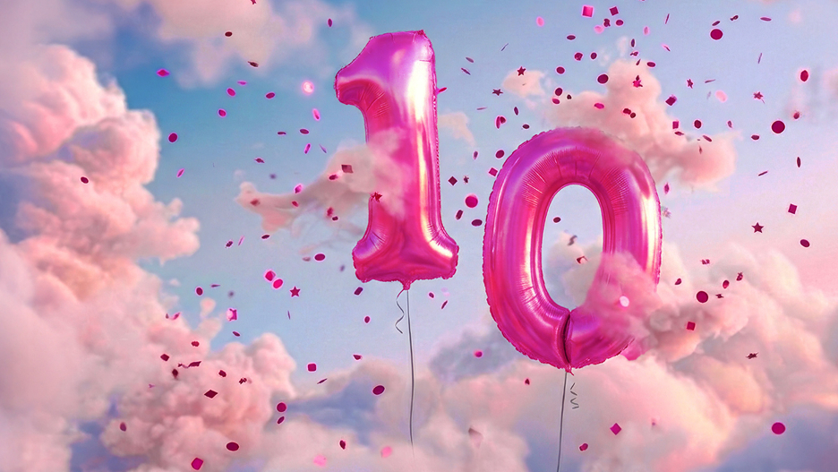 10 years of European cloud excellence 2 magenta balloons and confetti in a cloudy sky